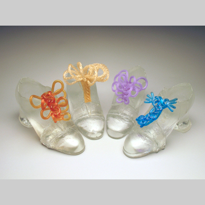 Shoes & Socks - Glass Slippers - Akin to the cement shoe, these glass slippers are weighty.  They may have beautiful bows, but one pays a price for wearing them. Hot Cast Glass & Kiln Cast lead crystal