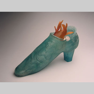 Shoes & Socks - Wild Fire - A woman trapped inside a shoe, with just her hand and hair extending out. Kiln-Cast lead crystal