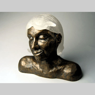 Portraits & People - Bronze Have More Fun - A pun of "Blondes have more fun."  What if skin color, instead of hair, was the determining factor?

The glass wig on this piece is removeable. Kiln-Cast lead crystal & bronze