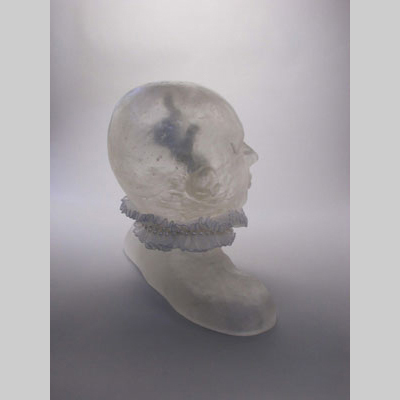 Portraits & People - Fetal Attraction - Inspired by the title of an extremely creepy movie, Fatal Attraction.  But in this case, there's a fetus floating inside a translucent head. Kiln-Cast lead crystal, ribbon & beads