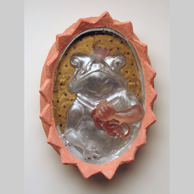 - Emerging Prince #1 - Frog inside the looking glass, with a human hand extending on the outside. Kiln-Cast lead crystal, cast glass & concrete