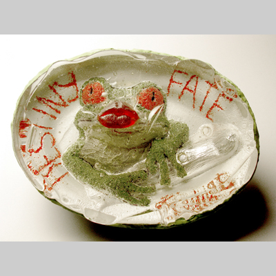 - Destiny, Fate, Kismet - A frog inside the glass with human lips extending outside the glass.  Inspired by the tale of the frog prince. Kiln-Cast lead crystal, cast glass & concrete