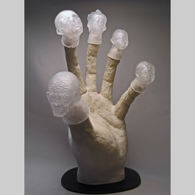 Portraits & People - Transparency - Clearly these heads/finger puppets are being controlled by something larger than themselves.  But their individual facial expressions indicate that their emotional responses to their lack of self-control vary widely. kiln cast lead crystal & concrete