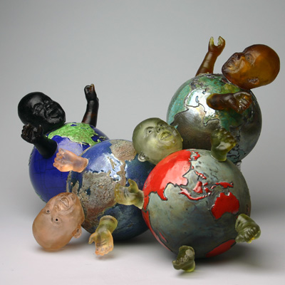 Bombs & Babies - It's a Small World - Globes with baby heads, hands and feet.  They all have names of internet companies which have made the world a smaller place. Kiln-Cast lead crystal knitted glass & raku