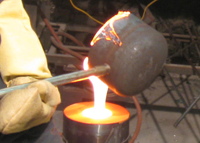 Pouring molten glass into a resin sand mold